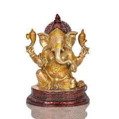 Brass Ganesha statue idol with detailed crown and red accents on round base