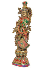 Brass Radha idol statue shown in side view, gold detailing with green and red dress