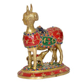 Brass Kamdhenu cow with calf showpiece, side view with red painted pattern and ornaments