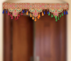 Ornate toran door hanging with circular motifs and multicolor tassels (blue, orange, green)