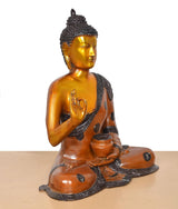 Brass Buddha idol 3/4 view, Abhaya Mudra hand raised, seated cross-legged