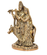 Brass Radha-Krishna idol with cow, three-quarter view, ornate jewelry and drapery