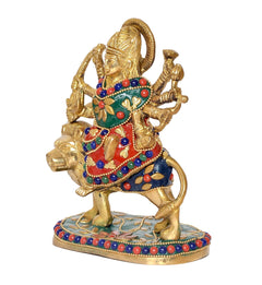 Close-up Durga Maa brass idol on lion, colorful floral and bead patterns