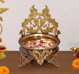 Brass peacock urli decorative bowl with flower petals inside