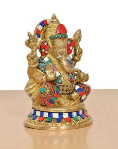 Brass Ganesha idol in seated pose, colorful jeweled arm bands and crown