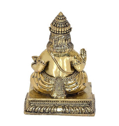 Kuber idol statue from behind, bronze-gold finish, headdress and raised hands
