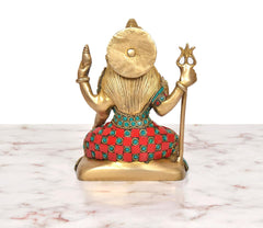 Rear view of Lord Shiva brass statue with trident, beaded multicolor dress