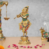Brass Krishna flute statue, gold figure with green, red and blue jeweled details