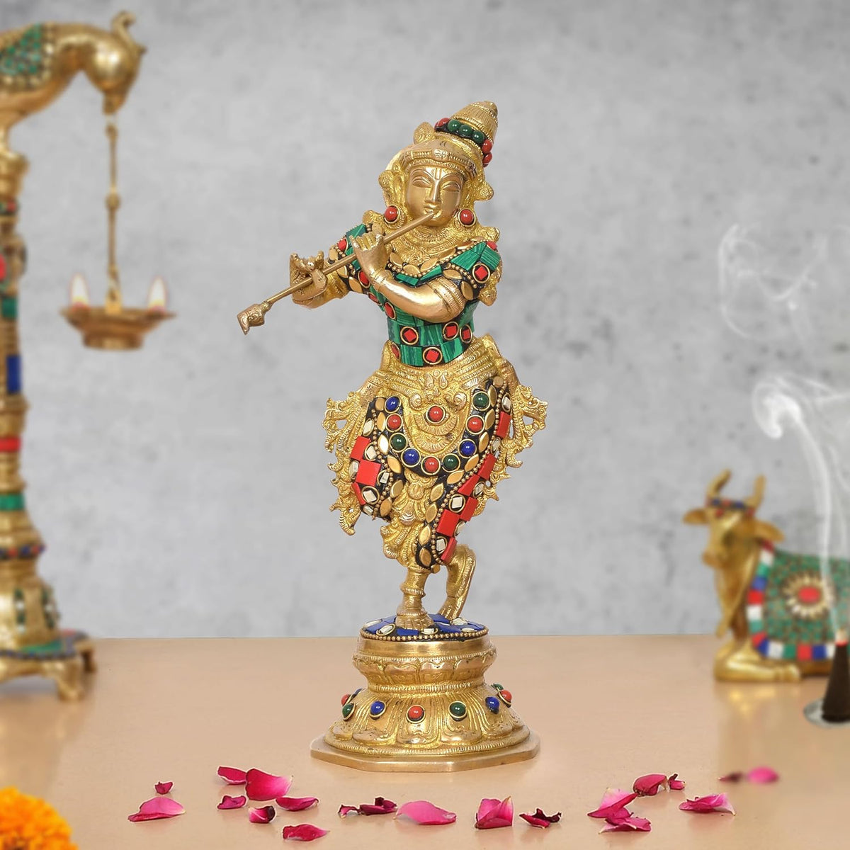 Brass Krishna flute statue, gold figure with green, red and blue jeweled details