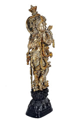 Krishna Bhagwan brass figurine, profile view, ornate ornaments and crown, dark pedestal, 29 in.