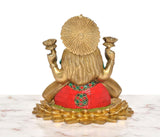 Brass Lakshmi idol back view, ribbed hair design, red tiled dress, lotus base