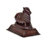 Nandi bull temple idol in dark bronze brass finish on pedestal, front-left view