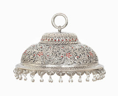 Silver metal chatta lid with ornate scrollwork and dangling beads at bottom edge