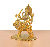 Durga Maa metal idol on lion, angled view with trident and four-armed stance