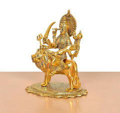 Durga Maa metal idol on lion, angled view with trident and four-armed stance