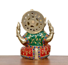 Back view of brass Ganesha idol, jeweled green-red outfit with detailed circular halo