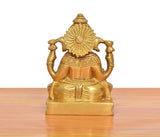 Brass Ganpati murti rear view, circular halo, seated on tiled pedestal, golden