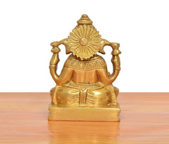 Brass Ganpati murti rear view, circular halo, seated on tiled pedestal, golden
