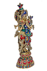 Krishna brass sculpture three-quarter view, detailed gold filigree and colorful jewels