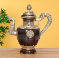 Dark brown brass Himalayan teapot with ornate lid finial and two side handles