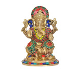 Ganesha brass murti with four hands, jeweled red, green, blue garlands
