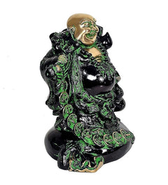 Laughing Buddha statue, gold head and green accents on dark robe, seated side view