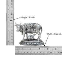 Brass cow with calf figurine; height 3 in and width 3.5 in shown