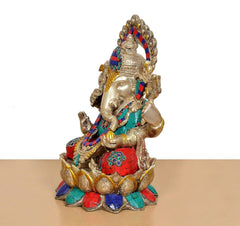 Side view: Brass Ganesha seated on lotus with multicolor tiled robe