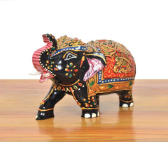 Wooden elephant showpiece, side view of black body with bright multicolor painted patterns