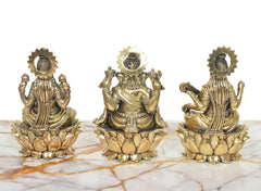 Brass Lakshmi, Ganesha, Saraswati idols facing front, each seated on lotus base