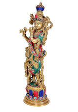 Brass Lord Krishna idol side view, colorful floral necklaces and teal dhoti