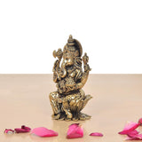Brass Lord Ganesha statue, three-quarter view, detailed torso, crown, and hands.