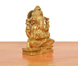 Ganesha idol side view, brass golden finish with ornate arms and robe