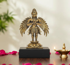 Standing Garuda idol statue, gold-tone, hands together, on dark base