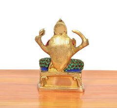Santoshi Maa brass statue, back view; gold detailing with teal-and-blue jeweled shoulder bands