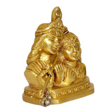 Radha Krishna idol side angle, gold-tone figures with flute and engraved base