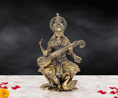 Brass Maa Saraswati idol, seated on lotus, holding veena