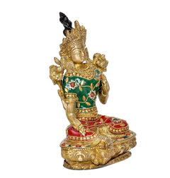 Brass Tara Devi idol, three-quarter view with ornate gold crown, green dress, red skirt