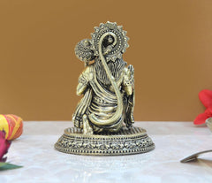 Hanuman Ji sitting brass statue with draped robe, long hair detail, and circular halo