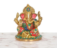 Brass Ganpati idol front view, gold-toned figure with red and turquoise stone-studded clothing