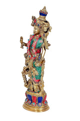 Side view of brass Radha Rani idol (15 in) with jeweled crown and ornate teal-red dress