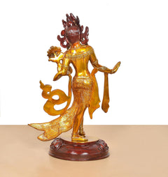 Brass Tara Devi dancing statue, three-quarter view, detailed dress and gold ornaments