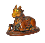 Seated brass Nandi bull statue, angled view showing head, neck ornaments, and base