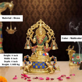 Brass Lakshmi statue, multicolor, 8 inch height; seated figure with bells and jeweled details