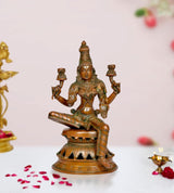 Brass Lakshmi statue seated in yoga pose, four arms holding oil lamps, 12 inch