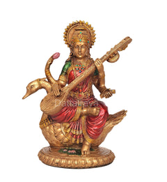 Saraswati idol statue on swan with veena; golden ornamented dress in red and green