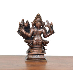 Copper Ganesha idol back view, seated with Riddhi, multi-armed sculpted frame