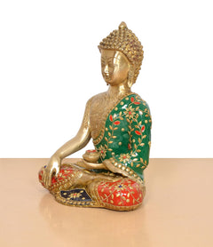 Brass Buddha statue side profile, seated pose with green floral robe and red accents