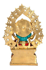 Rear view of brass Lakshmi idol on base, ornate frame halo with teal cloth
