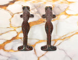 Jaguar-shaped brass door handles underside with mounting plates and animal-shaped grip